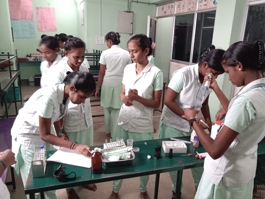 Vinayaga nursing students in skills lab using pipettes and test tubes for practical training exercises